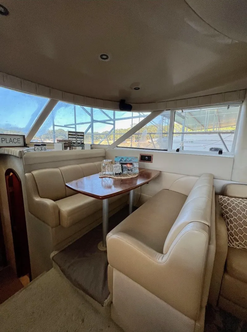 Slide: The Image of Interior of 2001 Cruisers Yachts 4450 Express Motoryacht with cozy seating and table. - 5