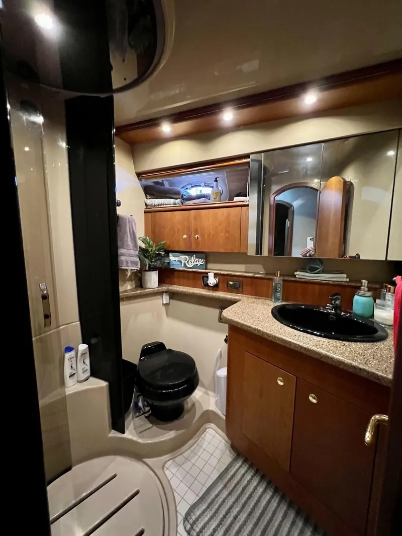Slide: The Image of Luxurious bathroom in 2001 Cruisers Yachts 4450 Express Motoryacht with modern amenities. - 6