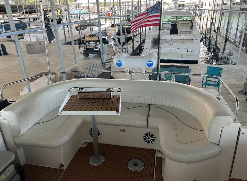 Slide: The Image of 2001 Cruisers Yachts 4450 Express Motoryacht with spacious seating and American flag. - 7