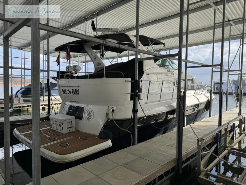 Slide: The Image of 2001 Cruisers Yachts 4450 Express Motoryacht docked in a marina. - 14