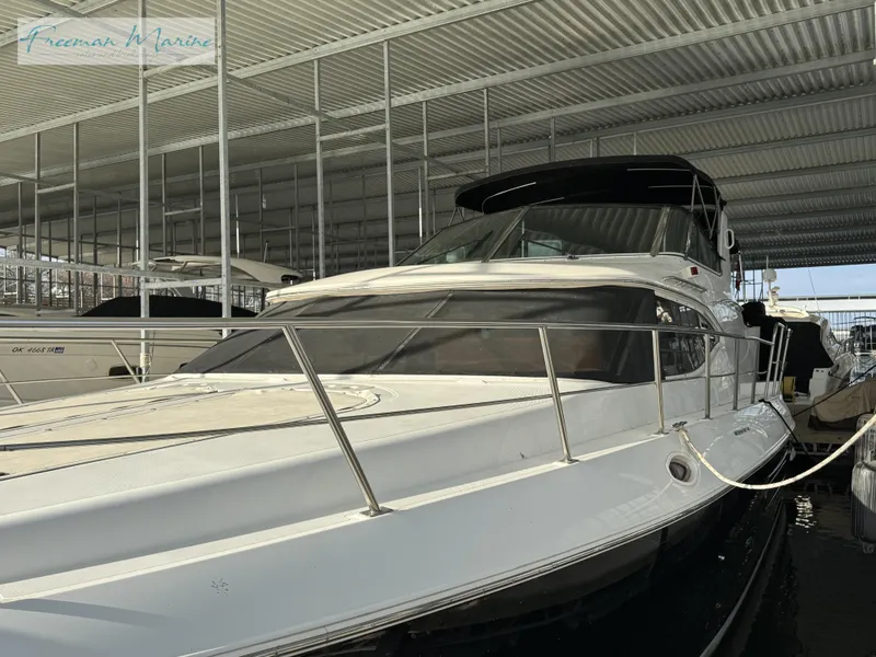 Slide: The Image of 2001 Cruisers Yachts 4450 Express Motoryacht docked in covered marina. - 23