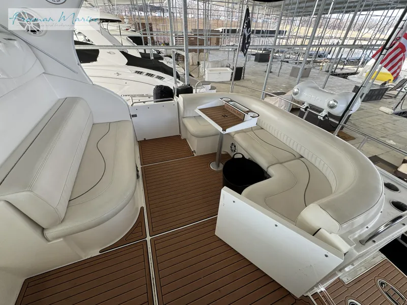 Slide: The Image of 2001 Cruisers Yachts 4450 Express Motoryacht interior with white seating and wooden flooring. - 27