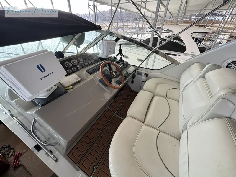 Slide: The Image of 2001 Cruisers Yachts 4450 Express Motoryacht helm with leather seating and navigation equipment. - 30