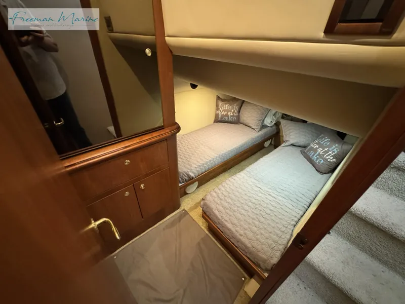Slide: The Image of 2001 Cruisers Yachts 4450 Express Motoryacht cabin with twin beds and cozy decor. - 37