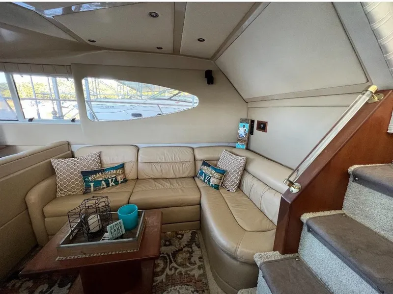 Slide: The Image of Luxurious 2001 Cruisers Yachts 4450 Express Motoryacht interior with beige leather seating. - 4