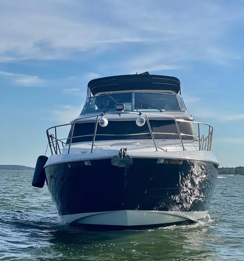 Slide: The Image of 2001 Cruisers Yachts 4450 Express Motoryacht on open water under blue sky. - 8