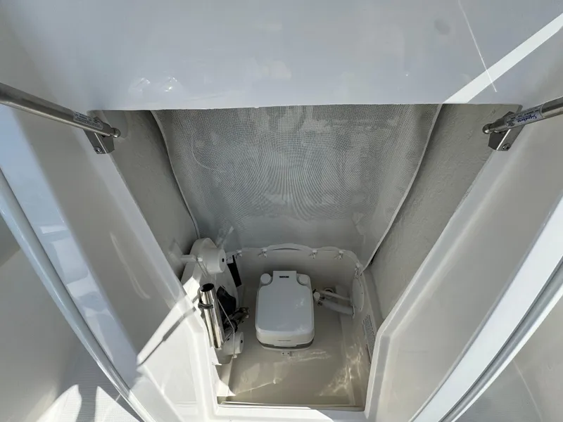 Slide: The Image of 2025 Sailfish 232 CC boat interior with compact marine toilet. - 10