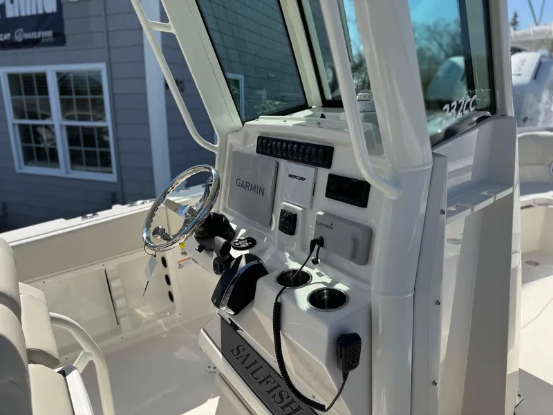 Slide: The Image of 2025 Sailfish 232 CC boat console with Garmin navigation and controls. - 11