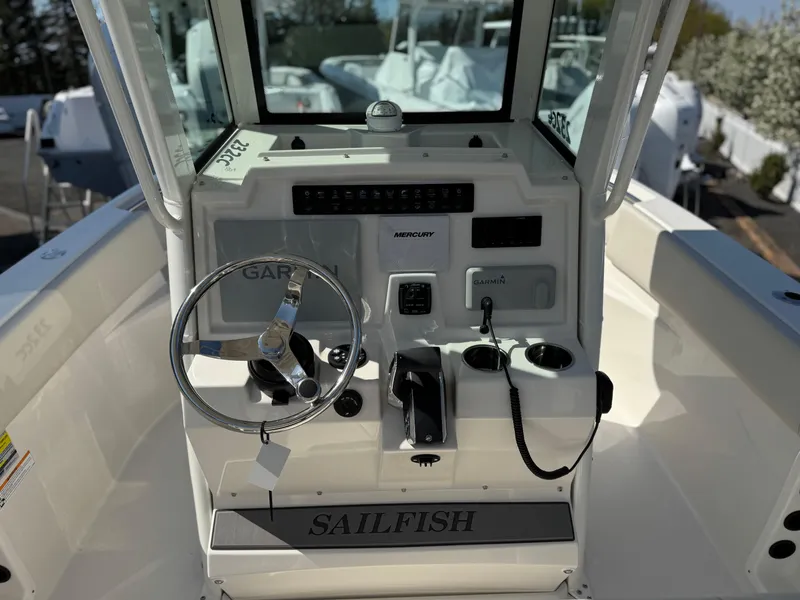 Slide: The Image of 2025 Sailfish 232 CC boat console with steering wheel and controls. - 12