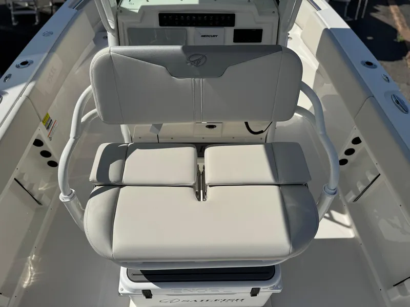 Slide: The Image of 2025 Sailfish 232 CC boat interior with cushioned seating and console. - 13