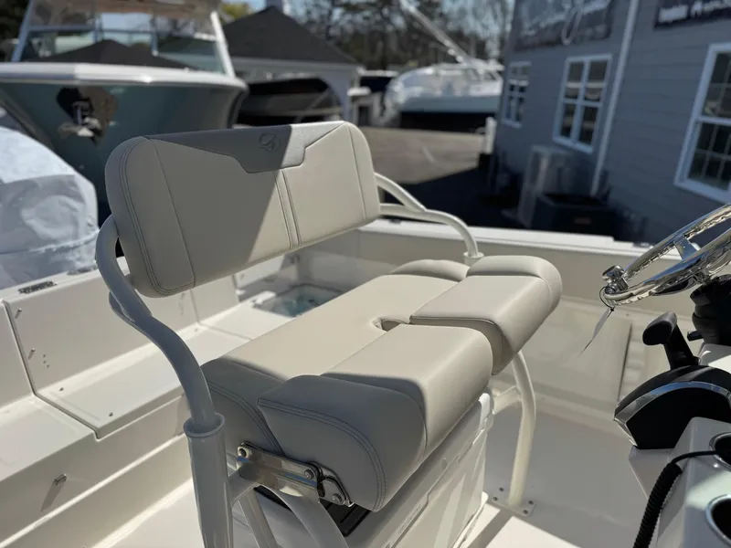 Slide: The Image of 2025 Sailfish 232 CC boat interior with cushioned seating and steering wheel. - 15