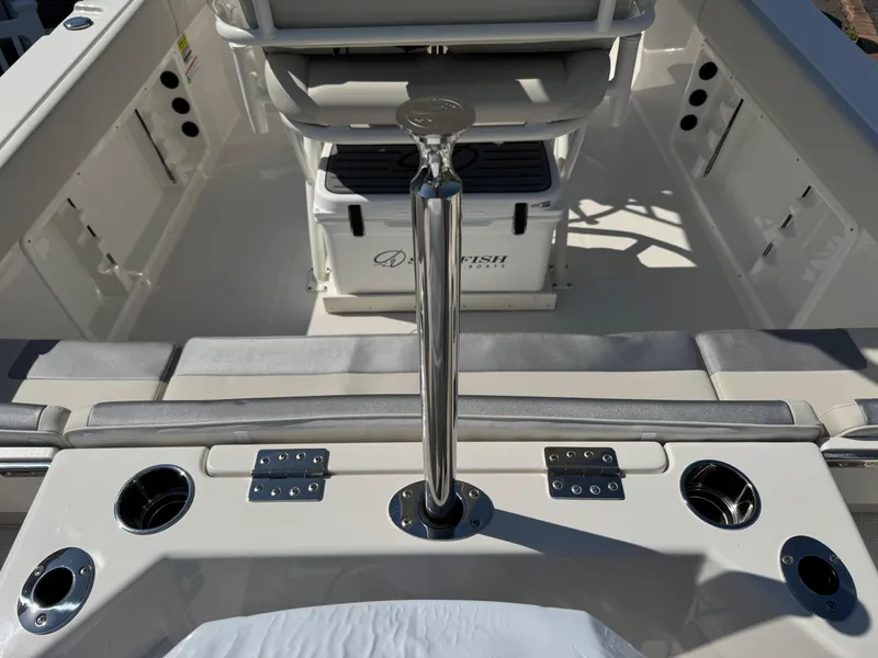 Slide: The Image of 2025 Sailfish 232 CC boat interior with rod holders and seating. - 17