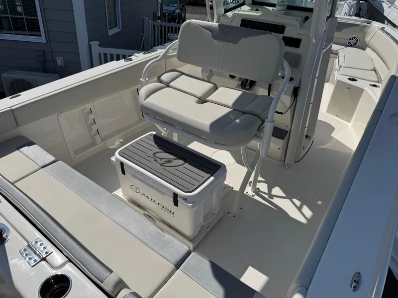 Slide: The Image of 2025 Sailfish 232 CC boat interior with seating and cooler on deck. - 19