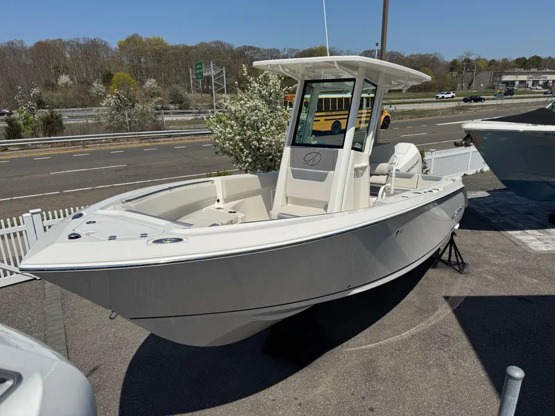 Slide: The Image of 2025 Sailfish 232 CC boat displayed outdoors on a sunny day. - 2