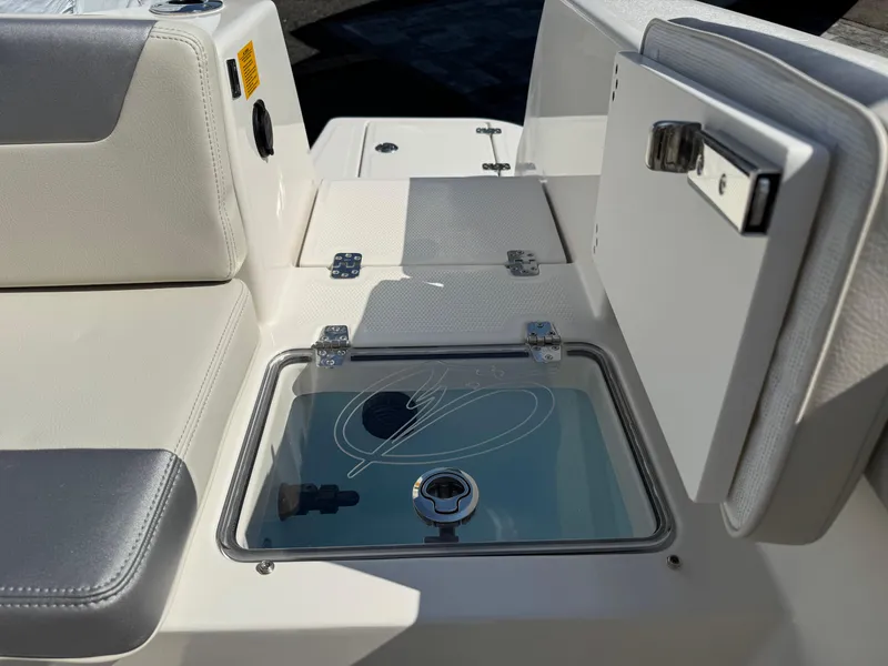 Slide: The Image of 2025 Sailfish 232 CC boat interior with storage compartments and seating. - 23