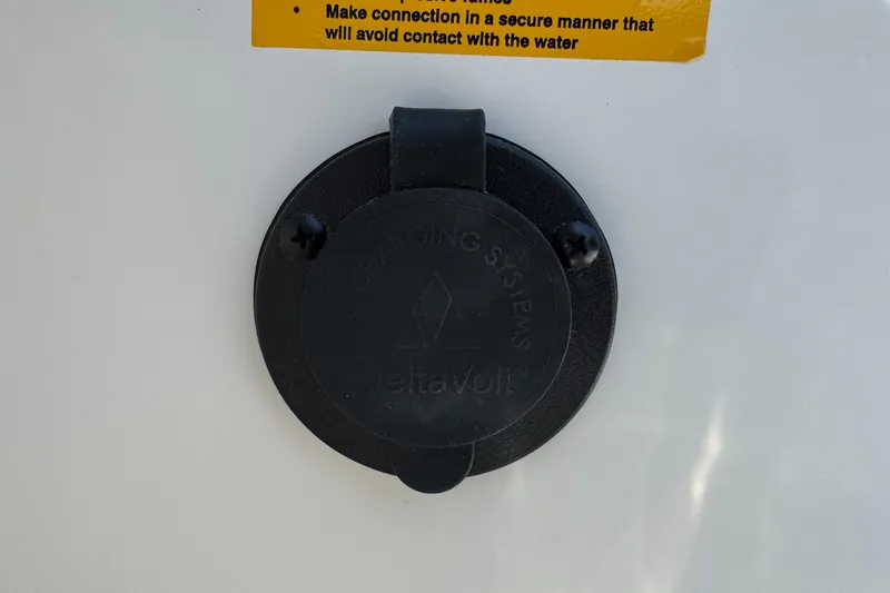 Slide: The Image of Charging port on 2025 Sailfish 232 CC boat with safety instructions. - 30