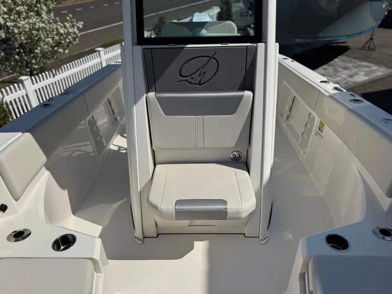 Slide: The Image of 2025 Sailfish 232 CC boat interior with white seating and cup holders. - 6