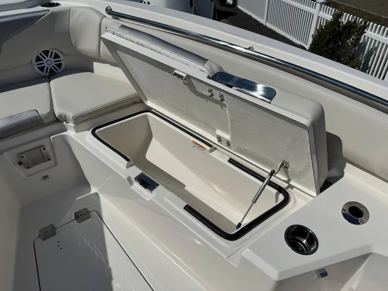 Slide: The Image of 2025 Sailfish 232 CC boat interior with open storage compartment and seating area. - 7