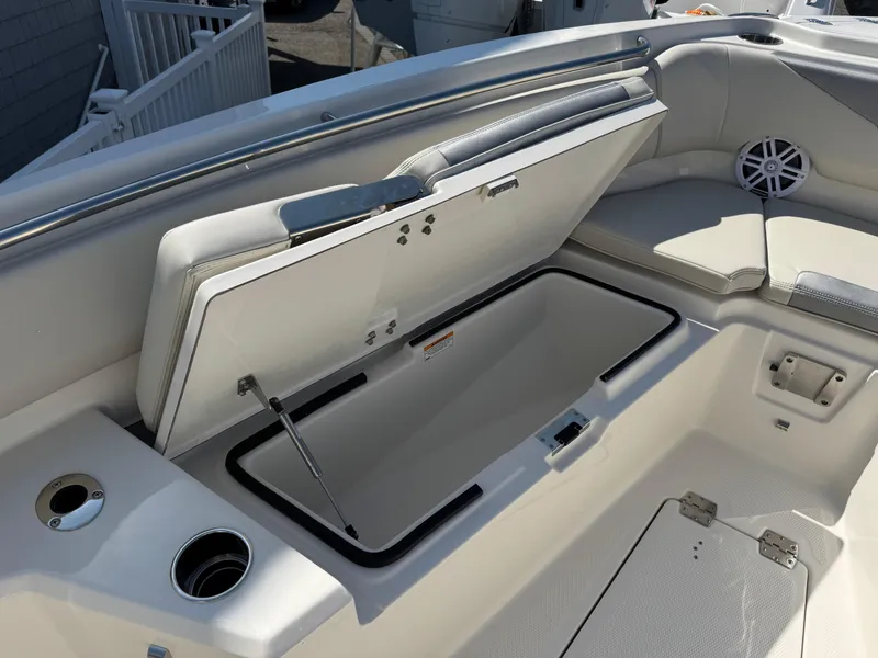 Slide: The Image of 2025 Sailfish 232 CC boat with open storage compartment and seating area. - 8