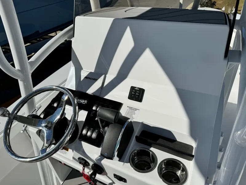 Slide: The Image of BlackJack 256 Coastal 2025 boat console with steering wheel and controls. - 14