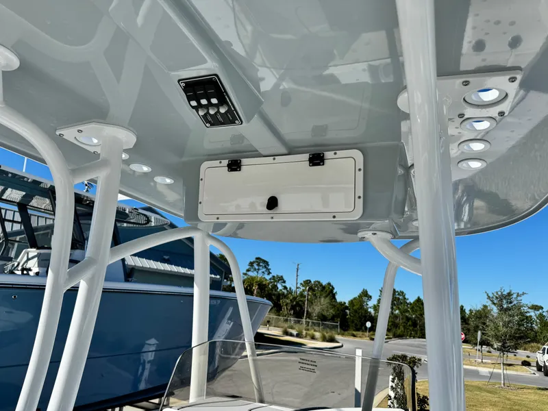 Slide: The Image of 2025 BlackJack 256 Coastal boat interior, featuring a sleek overhead console and sturdy framework. - 16