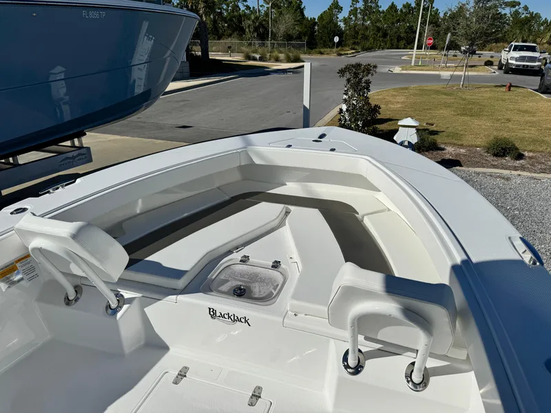 Slide: The Image of 2025 BlackJack 256 Coastal boat, white interior, parked outdoors. - 19