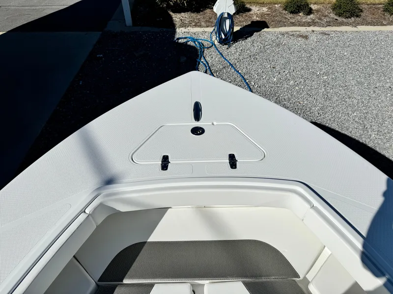 Slide: The Image of 2025 BlackJack 256 Coastal boat bow, featuring sleek design and storage compartment. - 21