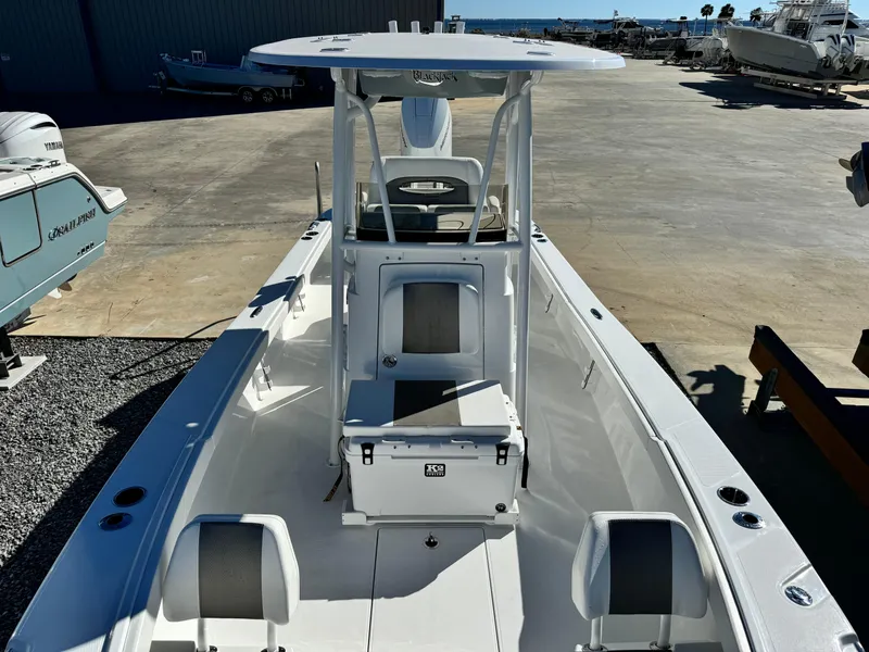 Slide: The Image of 2025 BlackJack 256 Coastal boat, white interior, center console, docked outdoors. - 23