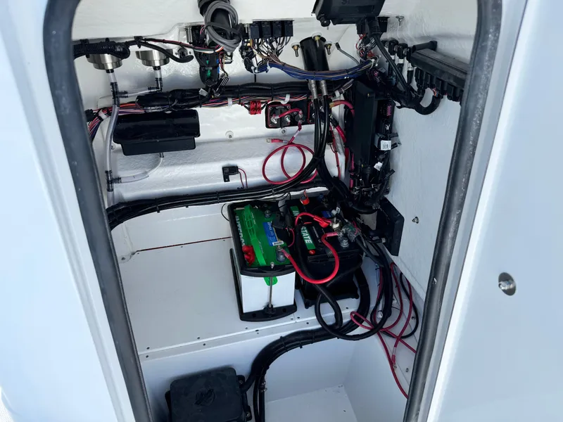Slide: The Image of 2025 BlackJack 256 Coastal boat electrical compartment with wiring and battery setup. - 28