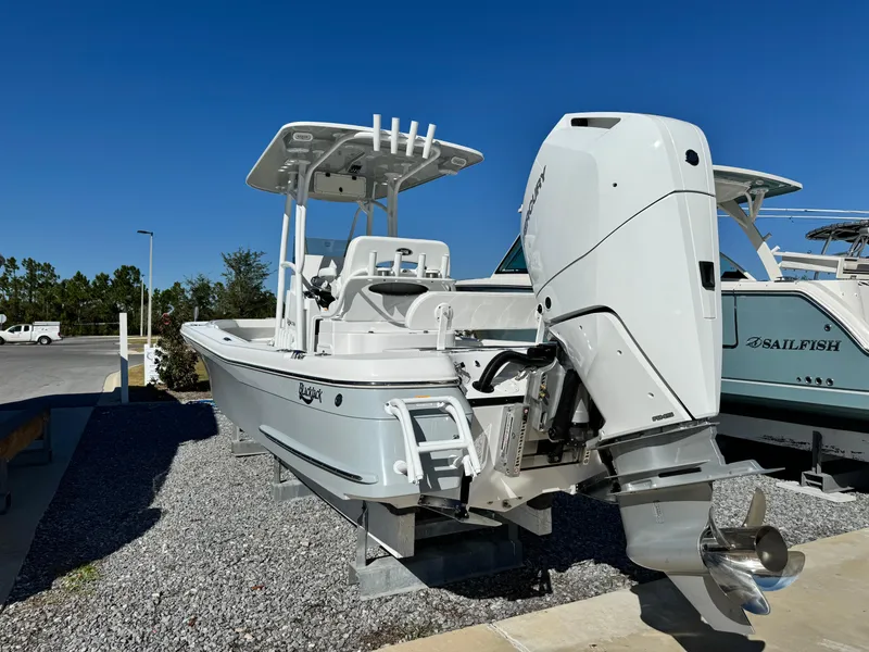 Slide: The Image of 2025 BlackJack 256 Coastal boat with powerful outboard motor, displayed outdoors. - 3