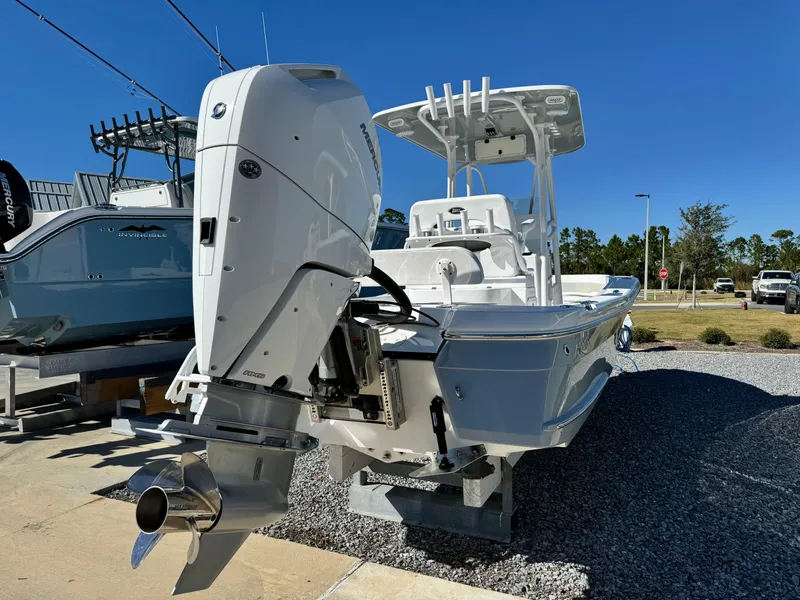 Slide: The Image of 2025 BlackJack 256 Coastal boat with powerful outboard motor, displayed outdoors. - 4