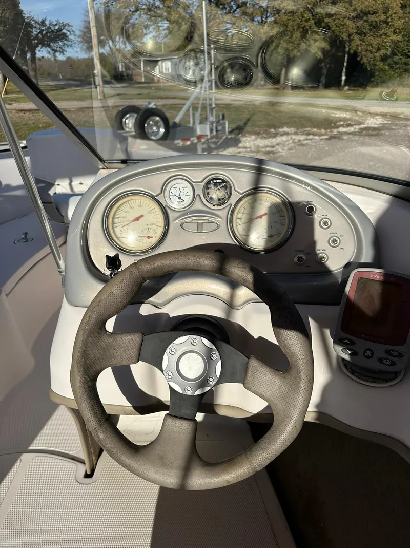 Slide: The Image of 2008 Tahoe Q5i Sport boat dashboard with steering wheel and gauges. - 10