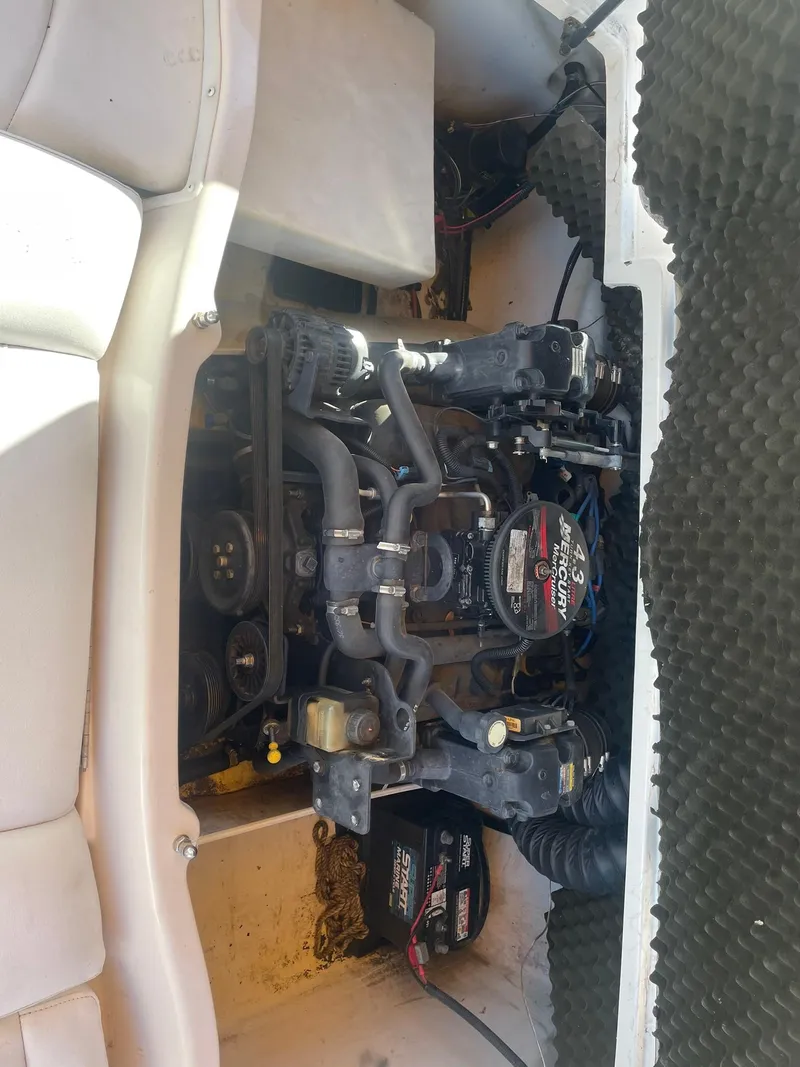 Slide: The Image of 2008 Tahoe Q5i Sport boat engine compartment with visible components and wiring. - 2