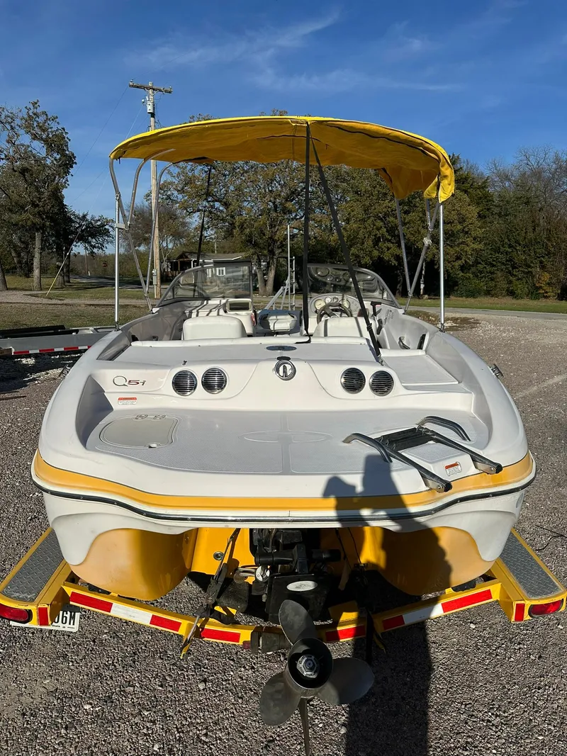 Slide: The Image of 2008 Tahoe Q5i Sport boat with yellow canopy, parked on gravel. - 3