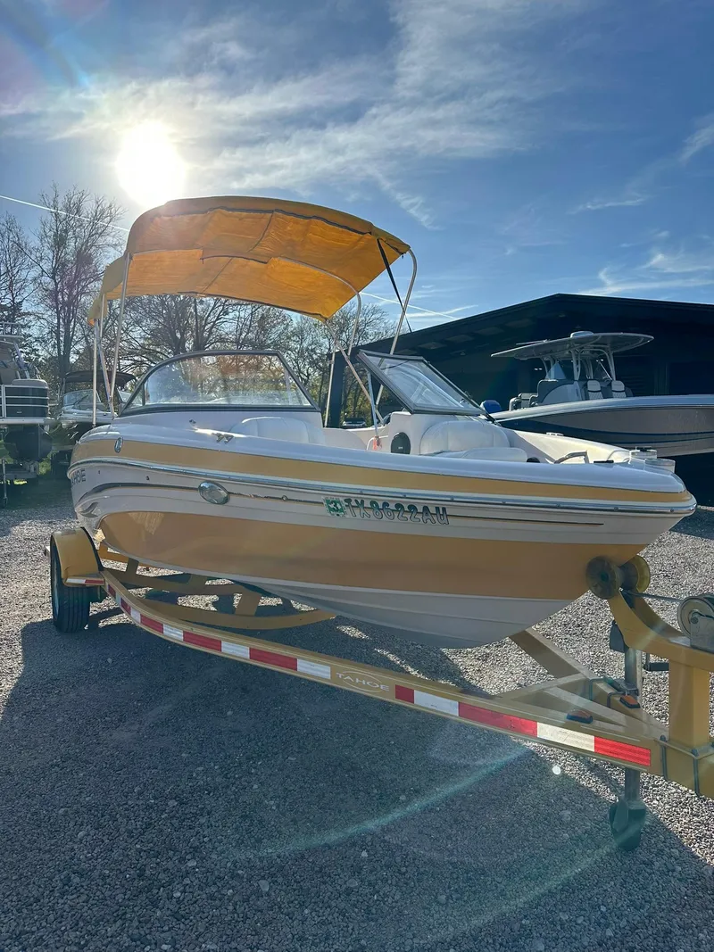 Slide: The Image of 2008 Tahoe Q5i Sport boat with yellow canopy on trailer, sunny day. - 5