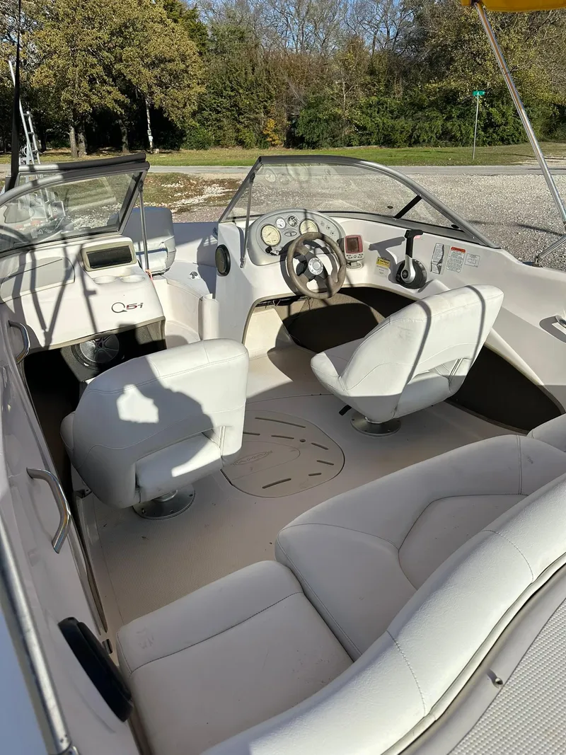 Slide: The Image of 2008 Tahoe Q5i Sport boat interior with white seating and steering wheel. - 8