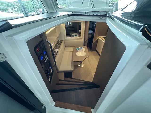 Slide: The Image of Interior view of 2024 Beneteau Gran Turismo 41 yacht, featuring modern seating and control panel. - 12