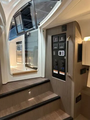 Slide: The Image of Interior view of 2024 Beneteau Gran Turismo 41 yacht with control panel and stairs. - 13