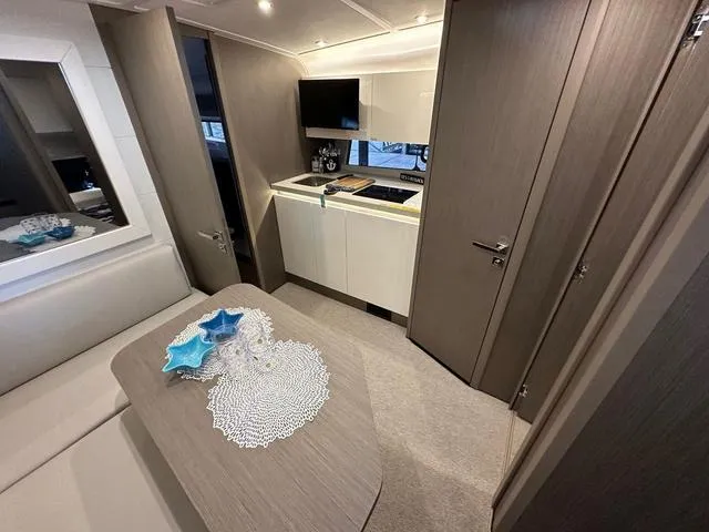 Slide: The Image of Luxurious interior of 2024 Beneteau Gran Turismo 41 yacht with modern kitchen and dining area. - 14