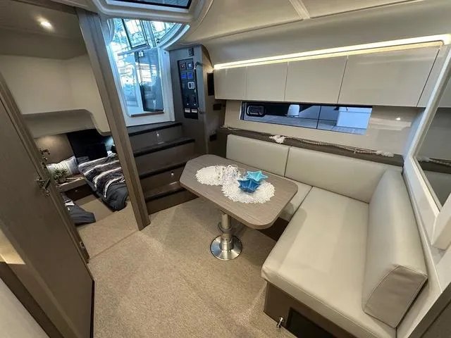 Slide: The Image of Interior of 2024 Beneteau Gran Turismo 41 yacht, featuring modern seating and dining area. - 15