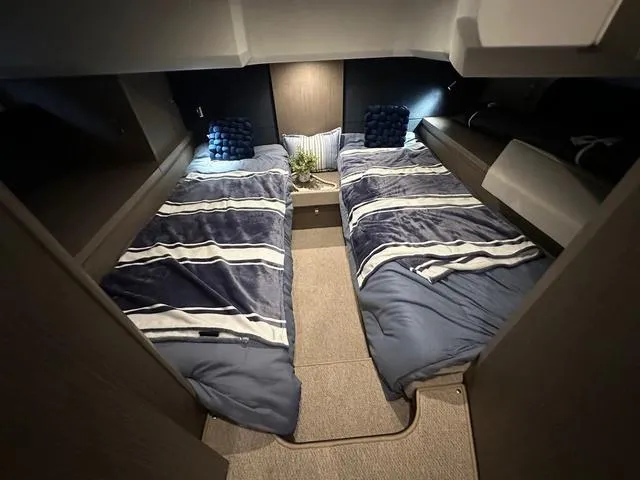 Slide: The Image of 2024 Beneteau Gran Turismo 41 cabin with twin beds and modern decor. - 16