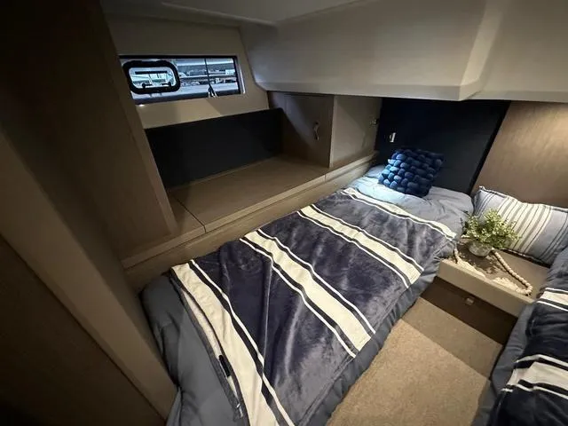 Slide: The Image of Luxurious cabin interior of 2024 Beneteau Gran Turismo 41 yacht with cozy bedding. - 17