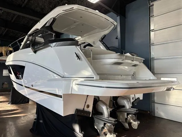 Slide: The Image of 2024 Beneteau Gran Turismo 41 yacht in showroom, rear view with dual propellers. - 22