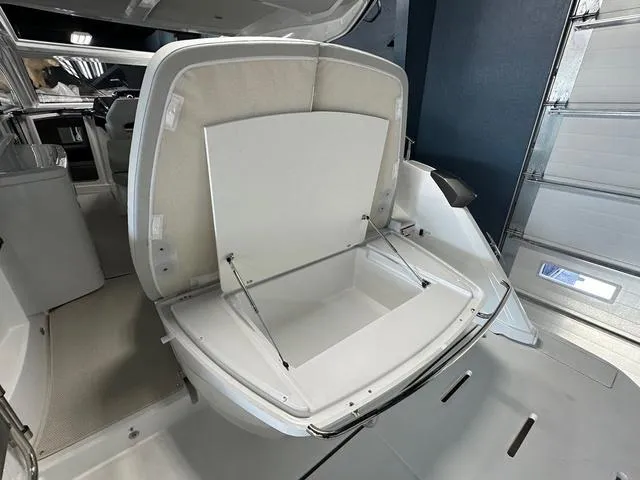 Slide: The Image of 2024 Beneteau Gran Turismo 41 boat storage compartment open, showcasing spacious interior. - 24