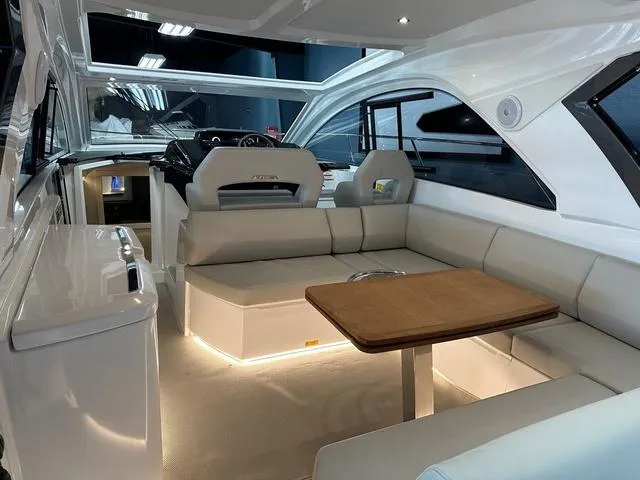 Slide: The Image of Luxurious interior of 2024 Beneteau Gran Turismo 41 yacht with elegant seating and table. - 4