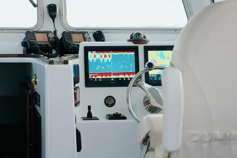 Slide: The Image of Modern helm of 2023 Millennium Marine NuWave 37 with advanced navigation displays. - 11