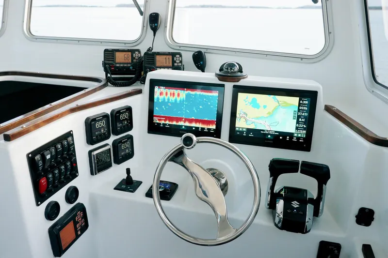 Slide: The Image of Modern helm of 2023 Millennium Marine NuWave 37 with advanced navigation systems. - 12
