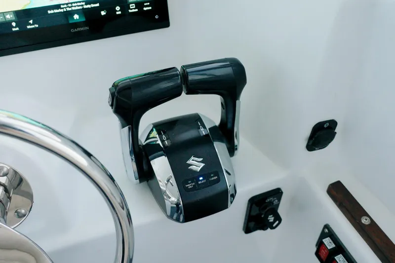 Slide: The Image of Millennium Marine NuWave 37 boat controls, featuring dual throttle levers and steering wheel, 2023 model. - 14