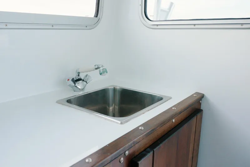 Slide: The Image of Millennium Marine NuWave 37 boat interior with sink, 2023 model. - 17