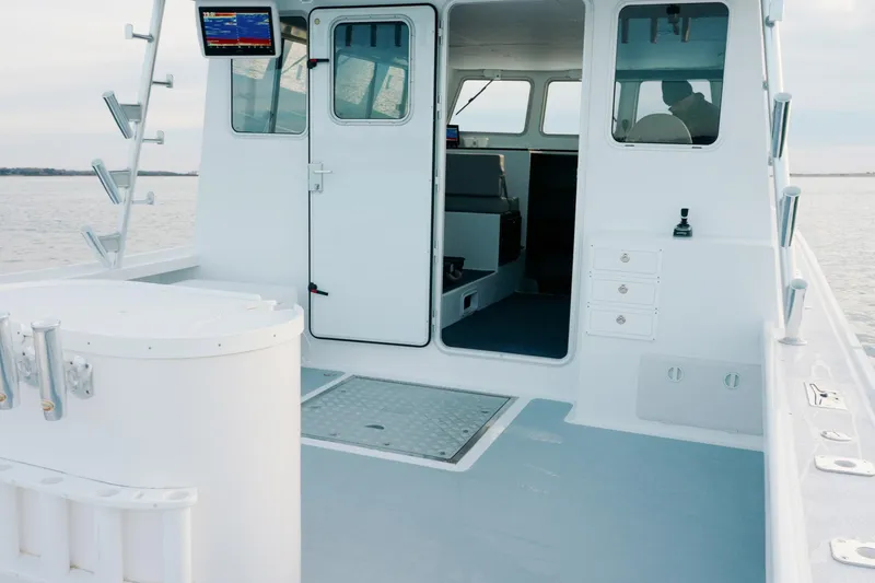 Slide: The Image of 2023 Millennium Marine NuWave 37 boat interior with open cabin and navigation equipment. - 18